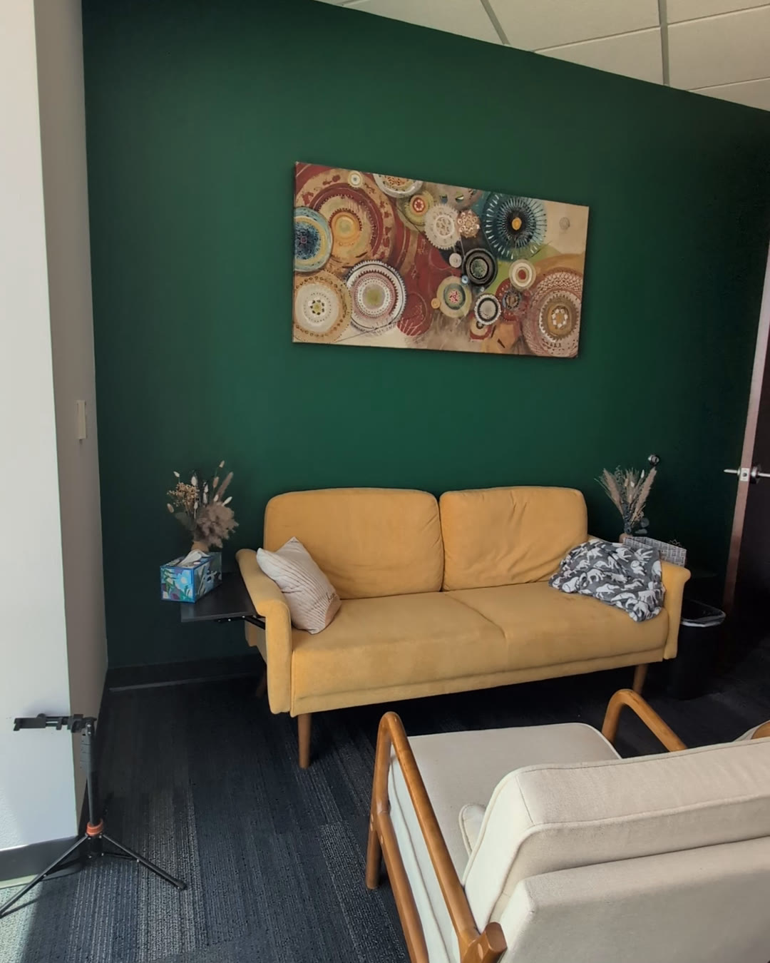 A warm, plant-filled therapy room at Calm Psych